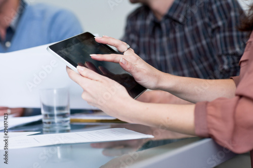 Photo: Woman using tablet computer in business meeting Woman using tablet computer in business meeting