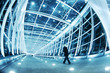 Photo: People walking in modern blue walkway interior People walking in modern blue walkway interior
