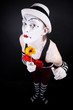 Funny mime in white hat with a bouquet of flowers Funny mime in white hat with a bouquet of flowers