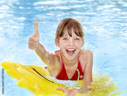 Photo: Child sitting on inflatable ring thumb up. Child sitting on inflatable ring thumb up.