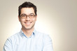 Young man with glasses smiling