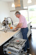 Senior man doing the dishes