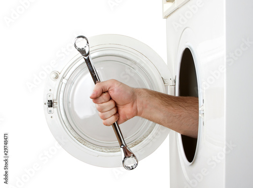 Photo: Repairman servicing washing machine Repairman servicing washing machine