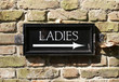 Signpost to public toilet .