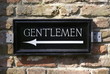 Signpost to public toilet .