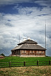 wooden cottage on green hill