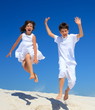 Children jumping on beach