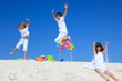 Children and pinwheels on sand