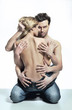 Conceptual portrait of a young posing couple in jeans