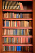 Old bookshelf with rows of books in ancient library