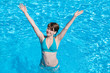 Young Happy Woman in Sunny Swimming Pool in Luxurious Hotel