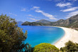 Sweeping white beach with blue sea and sky
