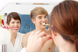 Young couple cleaning teeth