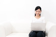 beautiful asian woman using laptop on the sofa