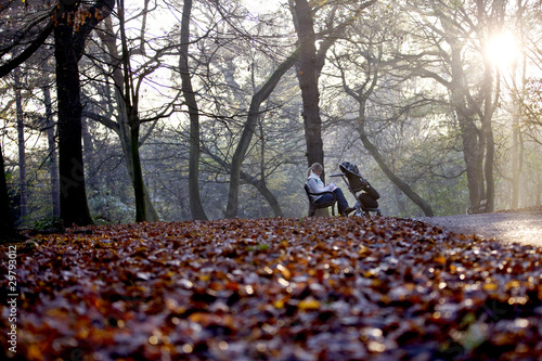 Photo: A young mother sitting on a bench, writing in a journal A young mother sitting on a bench, writing in a journal