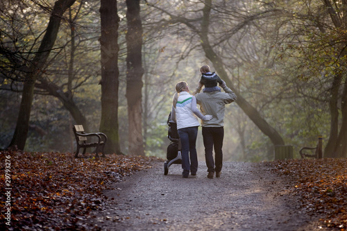 Photo: A family walking in the park A family walking in the park