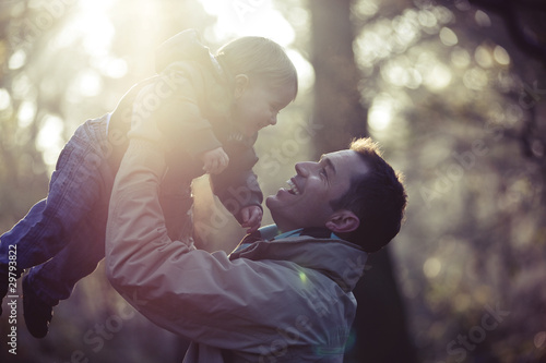 Photo: A father lifting his son in the air A father lifting his son in the air