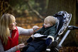 A young mother feeding her son in the park