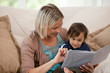 Mother looking at a book with her son Mother looking at a book with her son
