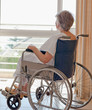 Senior woman in her wheelchair looking out the window Senior woman in her wheelchair looking out the window