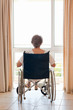 Mature woman in her wheelchair with her back to the camera Mature woman in her wheelchair with her back to the camera