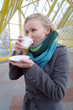 The young white girl drinks hot tea in the winter