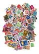 Large pile of postage stamps isolated on white