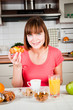 Beautiful woman holds sweet bun with fruits