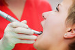 Image of young lady with dentist over her checking oral cavity . Image of young lady with dentist over her checking oral cavity .