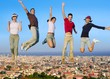 Jumping young people group on city buildings