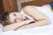 woman lying on her bed after having row with her boyfriend