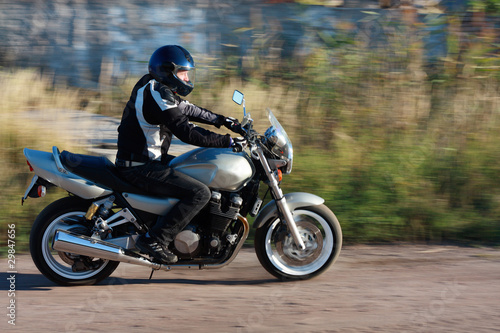 Photo: man riding a motorcycle on the road man riding a motorcycle on the road