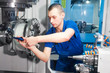worker operating CNC machine center