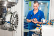 worker operating CNC machine center