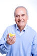 Man holding a piece of orange