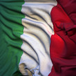 Flag of Italy, fluttering in the breeze, backlit rising sun