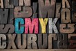 Photo: The letters 'CMYK' spelled out in very old letterpress blocks. The letters 'CMYK' spelled out in very old letterpress blocks.