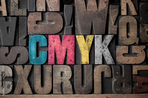 Photo: The letters 'CMYK' spelled out in very old letterpress blocks. The letters 'CMYK' spelled out in very old letterpress blocks.