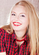 bright picture of lovely blond woman in checkered shirt
