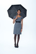 Smiling businesswoman holding umbrella
