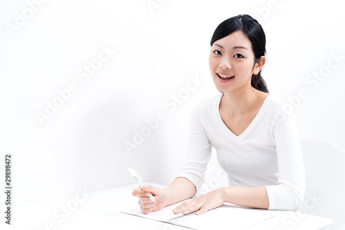 Photo: beautiful asian woman studying beautiful asian woman studying