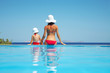 Young mother with daughter sitting on resort