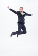 Enthusiastic businessman jumping mid-air