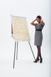 Confused businesswoman standing at flipchart with abundance of post-its