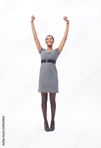 Photo: Enthusiastic businesswoman raising her arms Enthusiastic businesswoman raising her arms