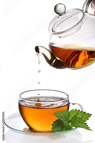 Photo: Tea dripping into cup (clipping path included) Tea dripping into cup (clipping path included)