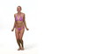 Pretty woman in swimsuit playing with frisbee