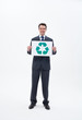 Smiling businessman holding recycling symbol