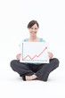 Smiling businesswoman holding ascending line chart