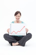 Smiling businesswoman holding ascending line chart